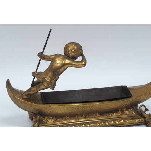 1276 - A Late XIX Century Gilt Metal Table Centrepiece, modelled as a cherub upon a gondola, the footed rec... 