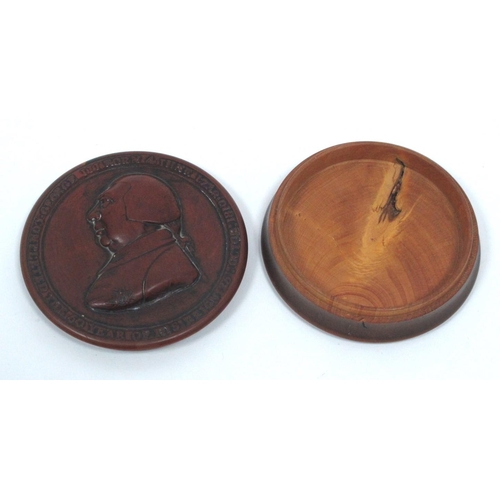 1326 - A George III Fruitwood Snuff Box, of circular form, the lid with a relief moulded bust and inscripti... 