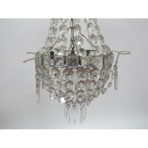 1330 - An Early/Mid XX Century 'Empire' Style Glass Chandelier, the facet cut top hung with prisms above a ... 