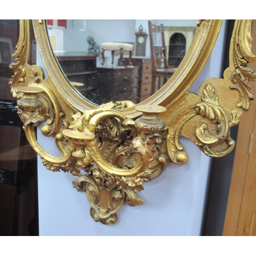 1333 - A XIX Century Giltwood and Gesso Girandole Wall Mirror, the plain oval plate with floral and scrolli... 