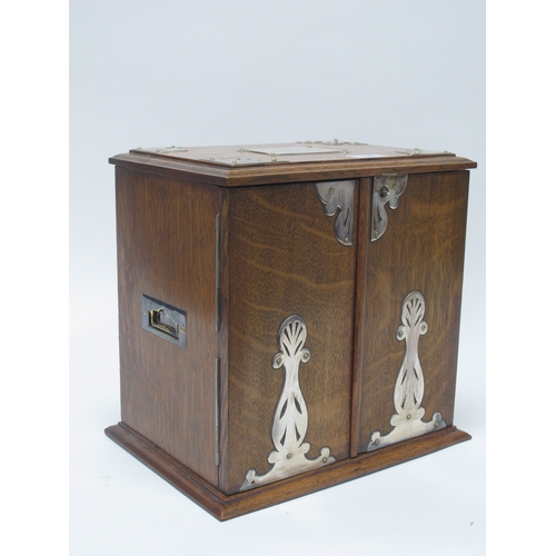 1266 - An Early XX Century Oak Cased Smokers Cabinet, of rectangular form with plated mounts and side carry... 