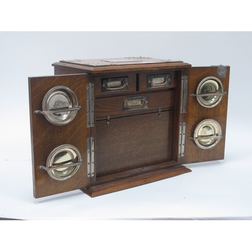 1266 - An Early XX Century Oak Cased Smokers Cabinet, of rectangular form with plated mounts and side carry... 