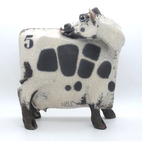 1063 - Lawson J. Rudge (b.1936) *ARR; A Raku Pottery Licking Flat Cow, spot pattern, numbered 5, unmarked, ... 