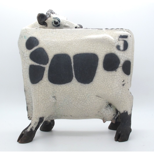 1063 - Lawson J. Rudge (b.1936) *ARR; A Raku Pottery Licking Flat Cow, spot pattern, numbered 5, unmarked, ... 