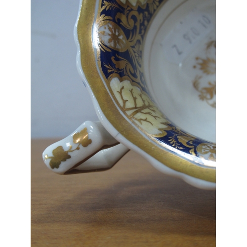 1044 - A Part Rockingham Porcelain Tea Service, painted in blue, cream and gilt with foliage and scrollwork... 