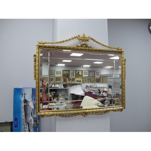 1623 - Rectangular Bevelled Wall Mirror, in a gilt frame with swags, vase and scrollwork applied to it, 85c... 