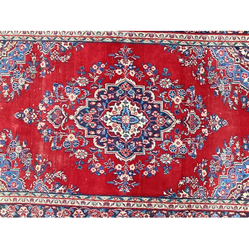 1617 - Middle Eastern Tassled Wool Rug, with floral decoration in the Indian manner, with large central mot... 