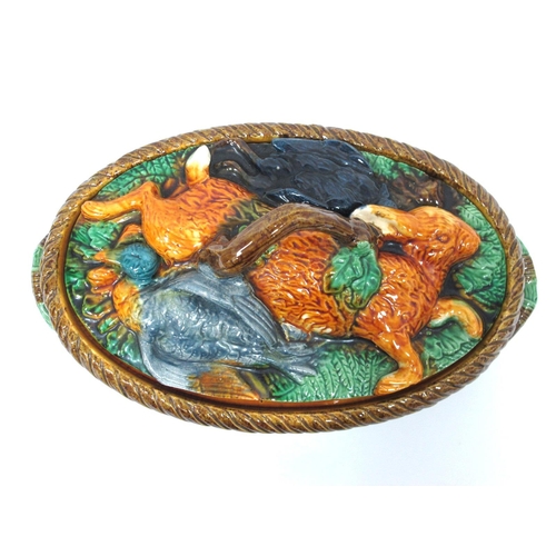 1111 - A Late XIX Century Majolica Game Pie Dish and Cover, of two handled oval footed form, the base mould... 