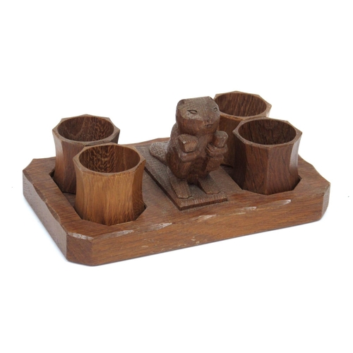 1302 - A Colin Almack 'Beaverman' Oak Napkin Set, carved with a central beaver and four napkin rings on a s... 