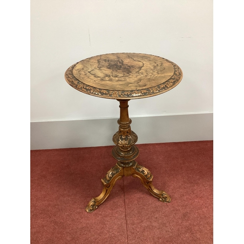 1530 - A XIX Century Walnut Pedestal Table, with a circular top and carved border, raised on a turned pedes... 