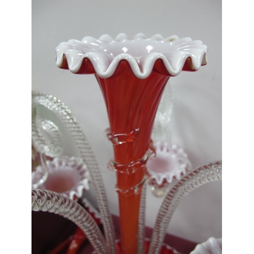 1033 - A Late XIX Century Red and White Glass Epergne, the shaped circular base with central trumpet vase s... 