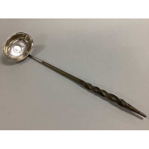 54 - A Georgian Toddy Ladle, the oval bowl with inset coin (rubbed), twisted handle, 33cm long.