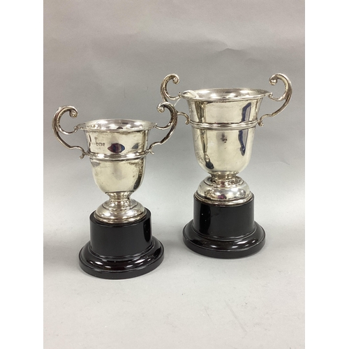 58 - A Hallmarked Silver Twin Handled Trophy Cup, (marks rubbed); on a black socle base (overall height 1... 