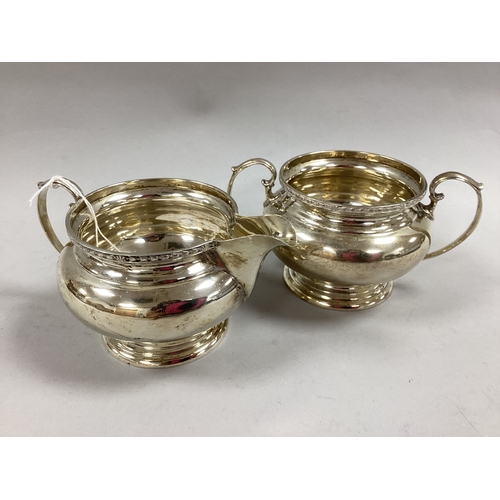 59 - A Hallmarked Silver Milk Jug and Twin Handled Sugar Bowl, London 1926, each of plain circular form w... 