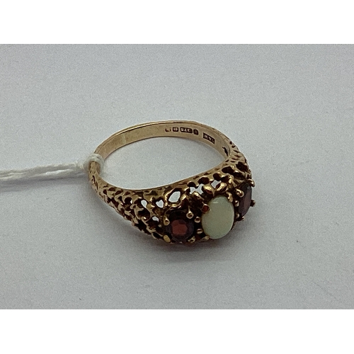 80 - A Vintage 9ct Gold Three Stone Ring, the cabochon centre stone to graduated side stones and highly d... 