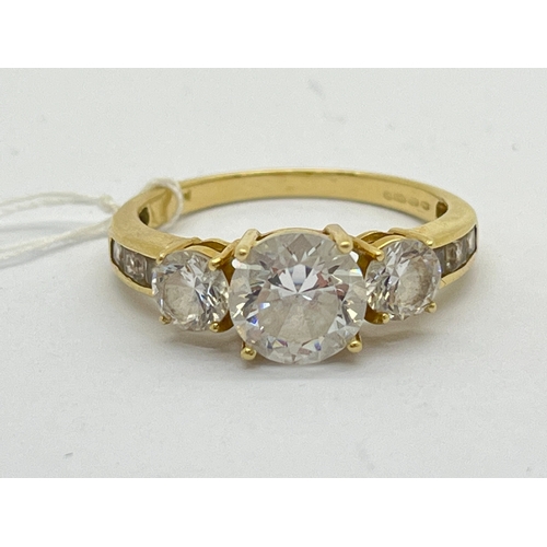 108 - A 14ct Gold Three Stone Dress Ring, the graduated stones to tapered line set shoulders stamped 