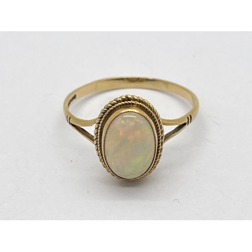 76 - A 9ct Gold Opal Single Stone Dress Ring, oval collet set between bifurcated shoulders (finger size S... 