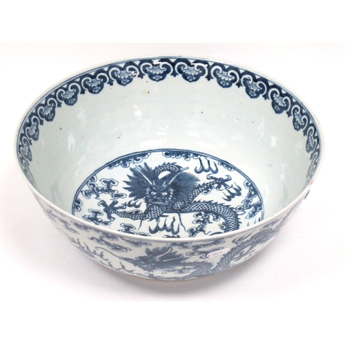 1121 - A Late XIX Century Large Chinese Pottery Circular Bowl, painted in blue with a central dragon chasin... 