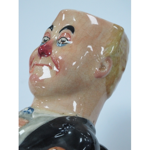 1056 - A Royal Doulton Pottery Toby Jug and Cover, 'George Robey' in Vaudeville make-up holding a cane, pri... 