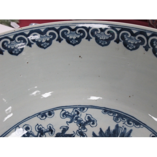 1121 - A Late XIX Century Large Chinese Pottery Circular Bowl, painted in blue with a central dragon chasin... 