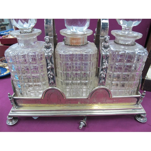 202 - A Spurrier & Co Plated Lockable Three Bottle Tantalus, with figural supports, raised on shapd feet, ... 