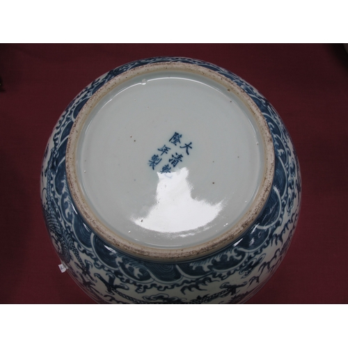 1121 - A Late XIX Century Large Chinese Pottery Circular Bowl, painted in blue with a central dragon chasin... 