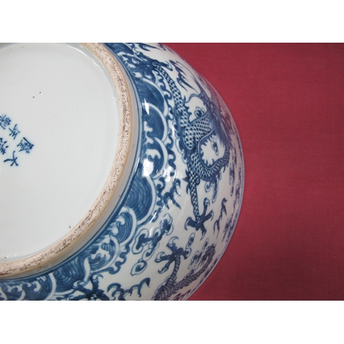 1121 - A Late XIX Century Large Chinese Pottery Circular Bowl, painted in blue with a central dragon chasin... 