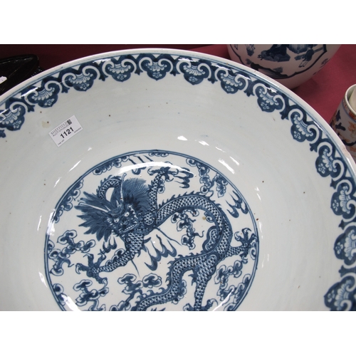 1121 - A Late XIX Century Large Chinese Pottery Circular Bowl, painted in blue with a central dragon chasin... 