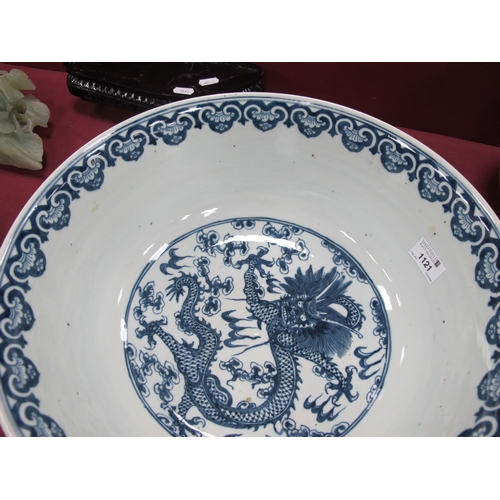 1121 - A Late XIX Century Large Chinese Pottery Circular Bowl, painted in blue with a central dragon chasin... 