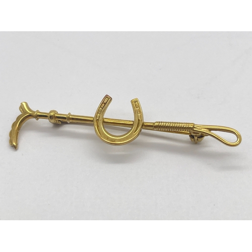 69 - A 9ct Gold Horseshoe and Crop Bar Brooch, pin stamped markers mark (indistinct), Birmingham import m... 