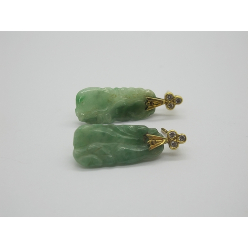 76 - A Pair of Carved Jade Drop Earrings, each with rubover set surmount; together with an oval panel pen... 