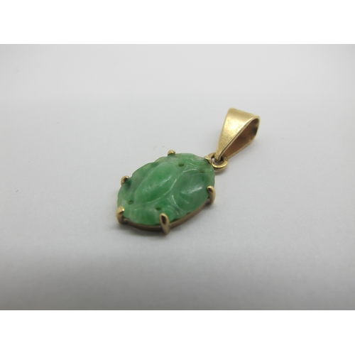 76 - A Pair of Carved Jade Drop Earrings, each with rubover set surmount; together with an oval panel pen... 