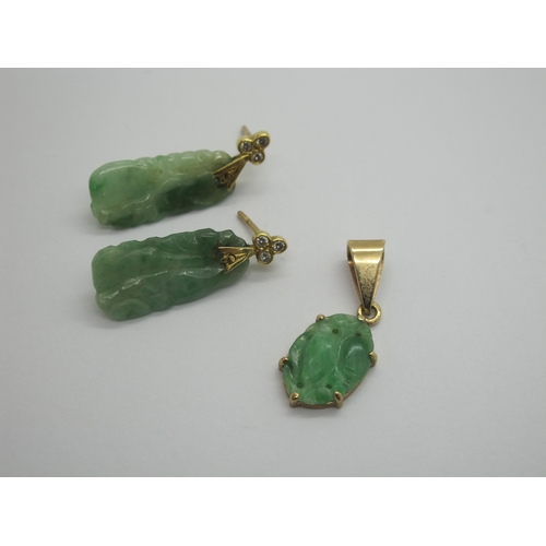 76 - A Pair of Carved Jade Drop Earrings, each with rubover set surmount; together with an oval panel pen... 