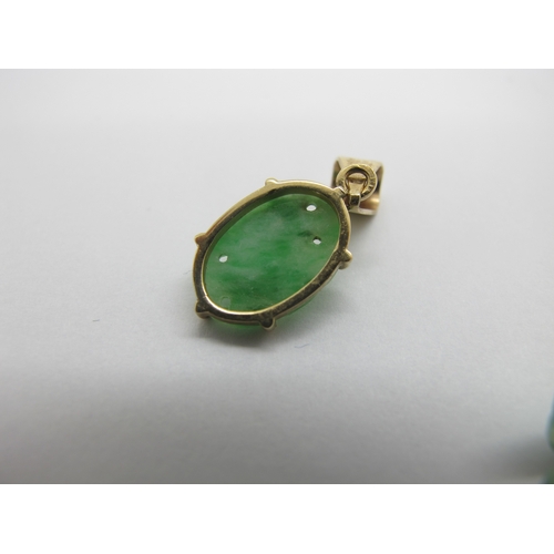 76 - A Pair of Carved Jade Drop Earrings, each with rubover set surmount; together with an oval panel pen... 