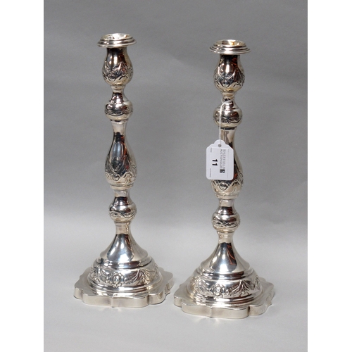 11 - A Pair of Hallmarked Silver Highly Decorative Candlesticks, London 1934, makers mark rubbed, engrave... 