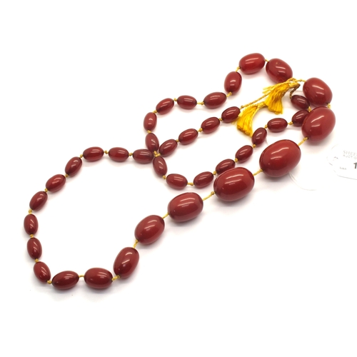 122 - A Single Strand Cherry Amber Coloured Bead String, comprising thirty nine knotted beads of graduated... 