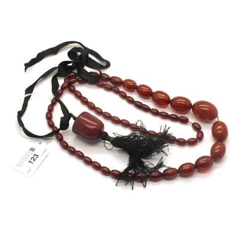 123 - A Single Strand Cherry Amber Coloured Bead Necklace, the graduated beads to screw barrel clasp, 90cm... 