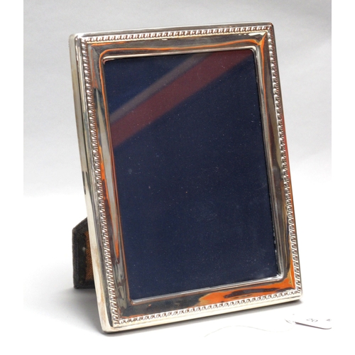 20 - A Modern Hallmarked Silver Mounted Rectangular Photograph Frame, HH, Sheffield 1988, on dark blue pl... 