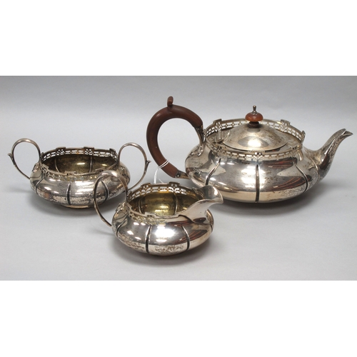 40 - A Hallmarked Silver Three Piece Tea Set, Walker & Hall, Sheffield 1912, each of compressed circular ... 