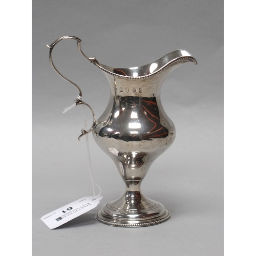 61 - A Georgian Hallmarked Silver Cream Jug, (marks rubbed), London 1784, with beaded edge and leaf cappe... 