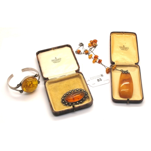 83 - An Art Deco Style Amber Colour Pendant, the fine chain with tumbled amber colour bead spacers, clasp... 