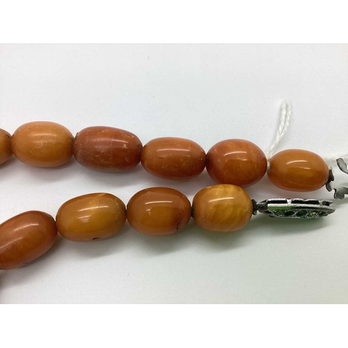 79 - A Graduated Single Strand Amber Colour Bead Necklace, (in need of restringing) approximately 44cm lo... 