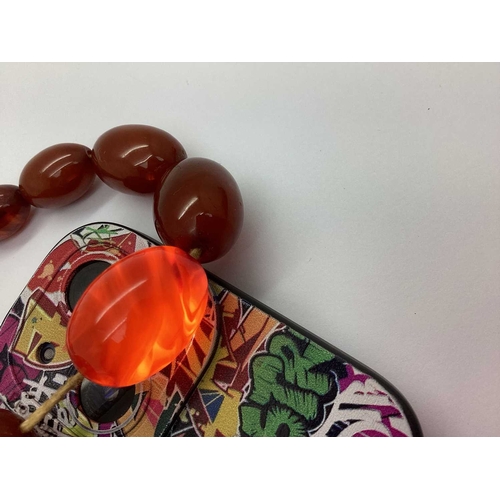 123 - A Single Strand Cherry Amber Coloured Bead Necklace, the graduated beads to screw barrel clasp, 90cm... 