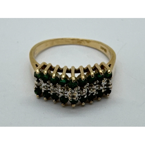 91 - A Diamond and Emerald Set Dress Ring, of three row design, illusion set to centre within claw set bo... 