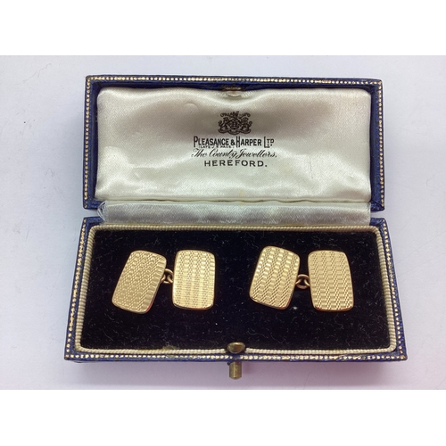 241 - A Pair of 9ct Gold Gent's Cufflinks, the rectangular shaped panels of engine turned design, on chain... 