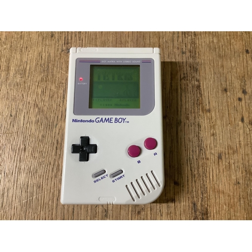 723 - A Nintendo Game Boy Hand Held Gaming Console, S/N G18942466, Owners Manual, Four Games Cartridges in... 