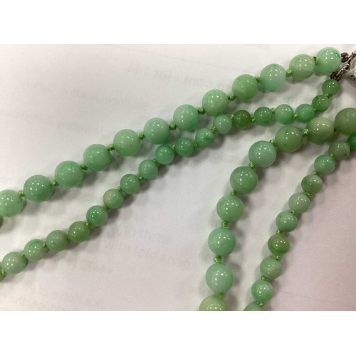 144 - JKa Kohle of Pforzheim; A Jade Bead Multi-row Necklace, the graduated beads knotted to fancy clasp s... 