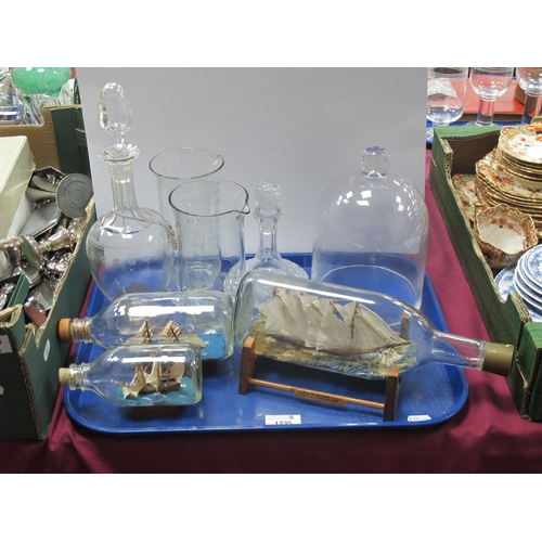 1235 - Two XIX Century Glass Measures, decanter, ships in bottles, glass dome:- One Tray.