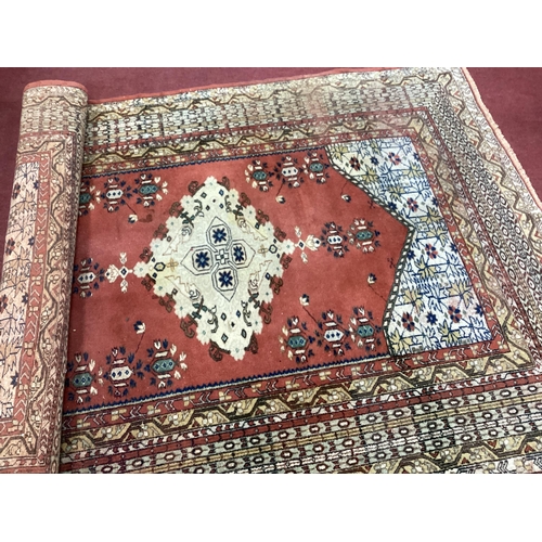 1541 - Middle Eastern Wool Rug, with geometric designs and hexagonal rust ground to centre, 218 x 160cm.