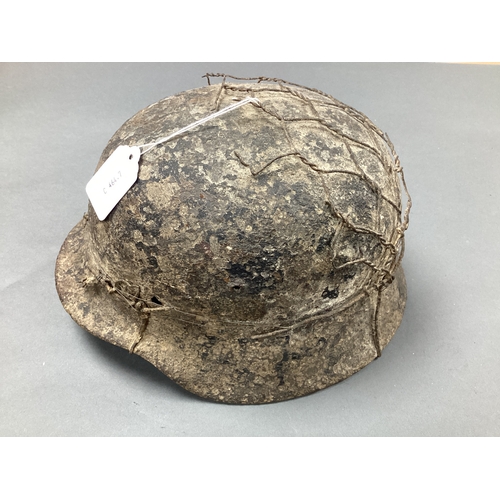 559 - WWII German Army M40/M42 Combat Helmet, with remnants of attached chicken wire half basket, shell on... 